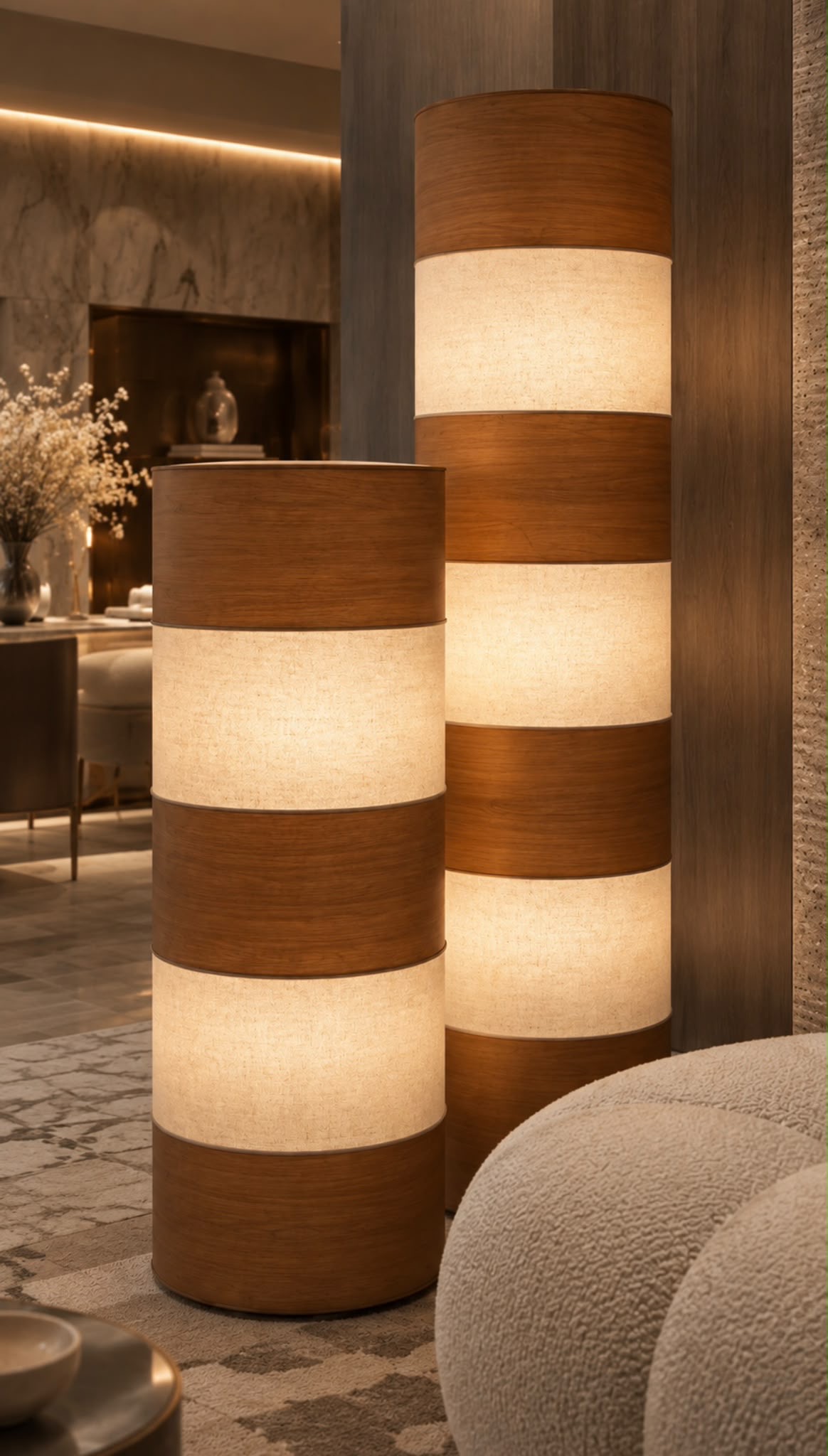 Rust-brown sofa and woven pouf before illuminated arched display niches with slim shelves and ceramic vessels by Maison Quari Vera